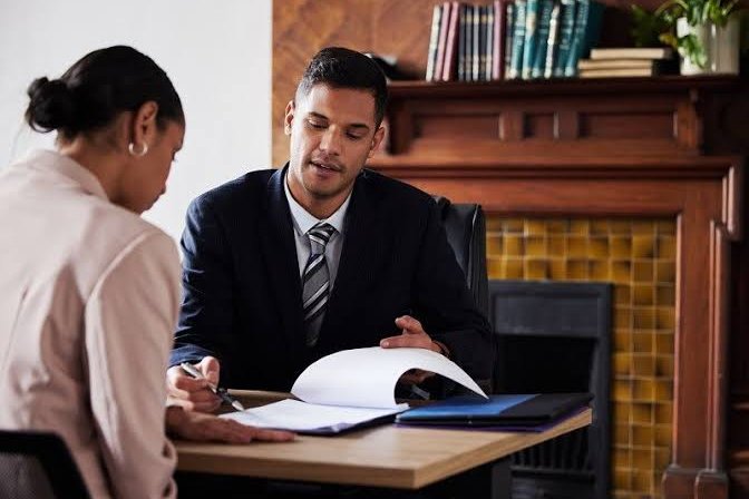 Attorney reviewing case documents with a client