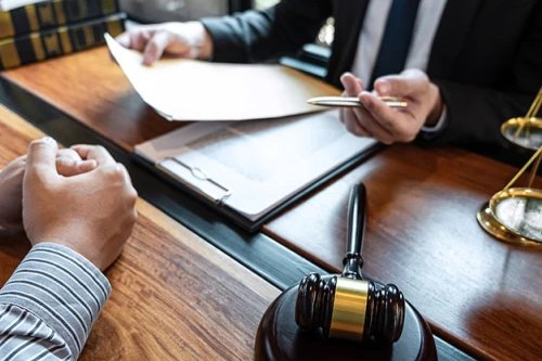 Legal paperwork being reviewed across a desk